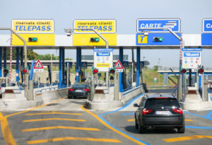 Rome, Italy – July 29, 2013: Cars at toll booths of Autostrade, the motorway to Rome – payment with telepass or card